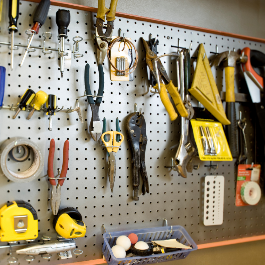 Garage Organization Tips with a pegboard full of hanging tools.