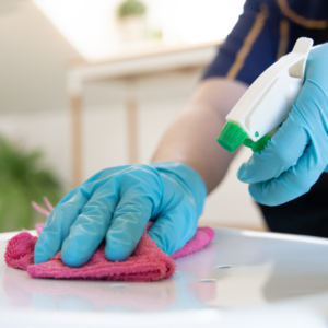 Woman scrubbing a table as example of a cleaning hack by Melissa.